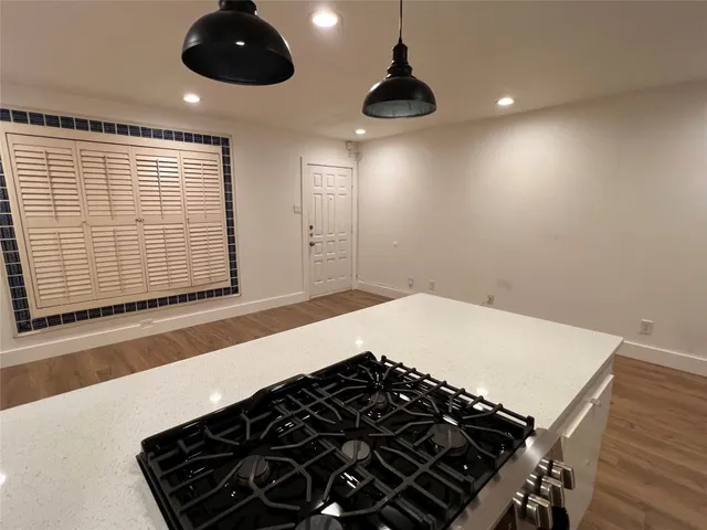 a view of hallway with wooden floor and door
