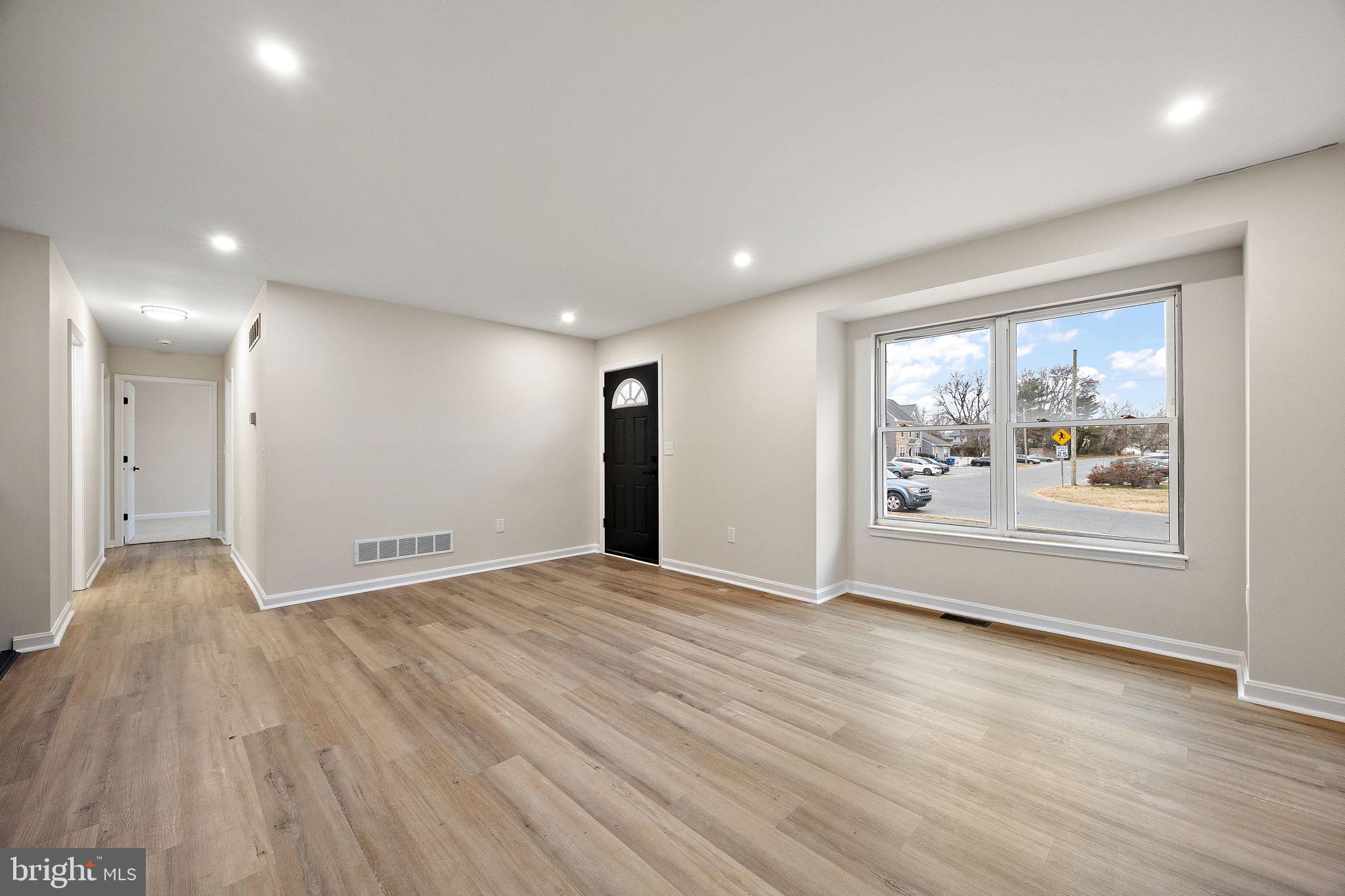 24 Bizarre Drive New Castle, DE 19720 - Photo 4 of 26 a view of an empty room with wooden floor and a window