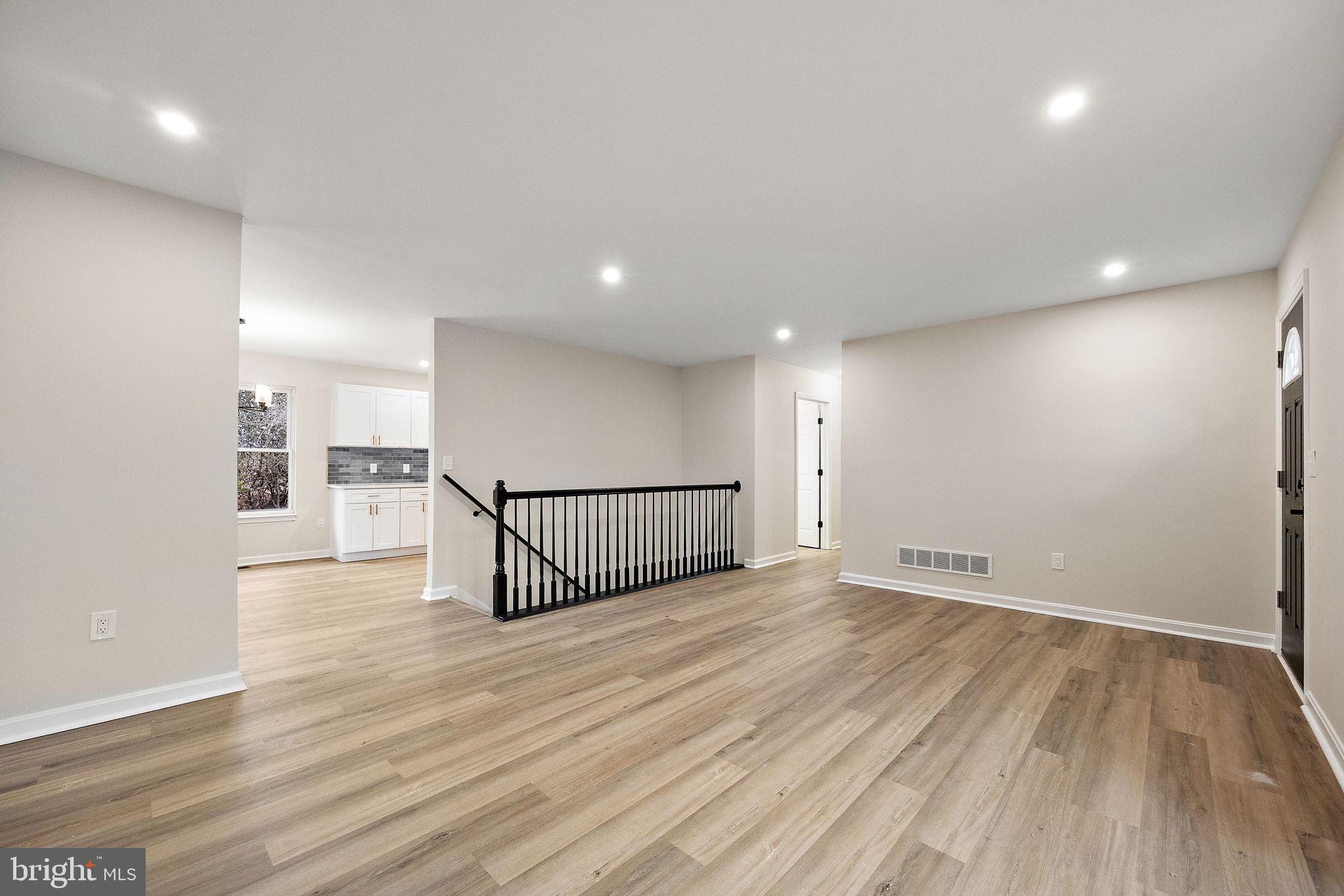 24 Bizarre Drive New Castle, DE 19720 - Photo 6 of 26 an empty room with wooden floor and windows