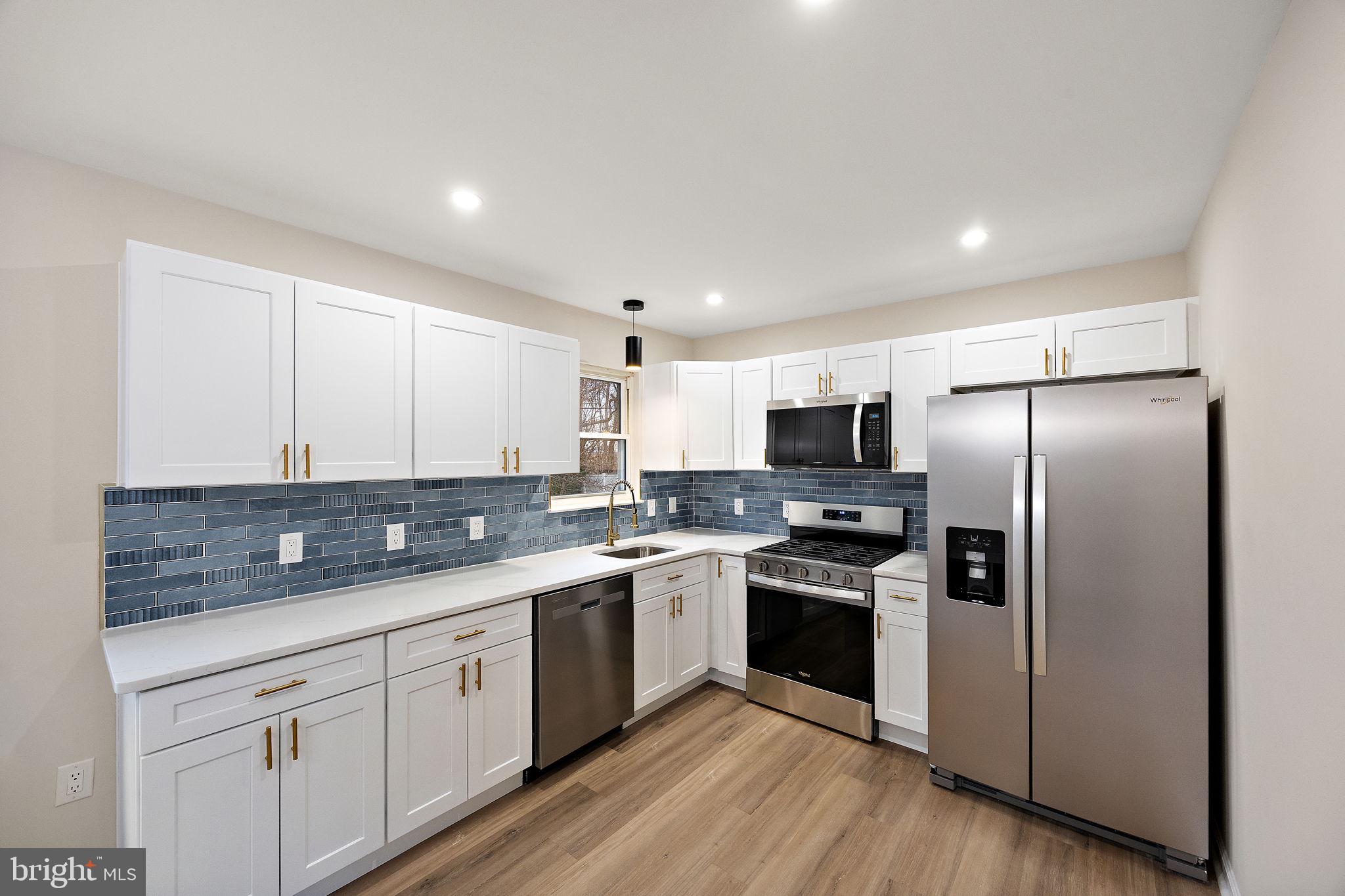 24 Bizarre Drive New Castle, DE 19720 - Photo 8 of 26 a kitchen with a sink stainless steel appliances and white cabinets