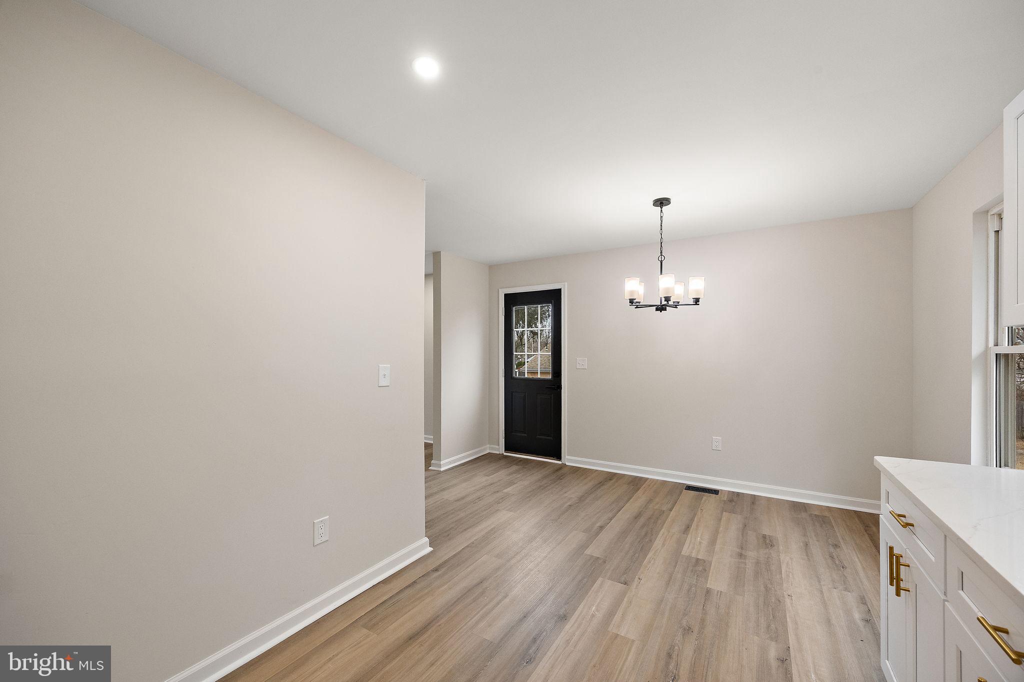 24 Bizarre Drive New Castle, DE 19720 - Photo 9 of 26 wooden floor in an empty room with a window