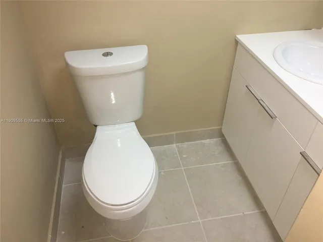 a bathroom with a toilet and a rug