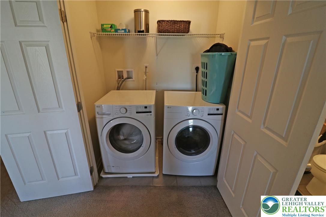 4502 Benjamin Court Emmaus, PA 18049 - Photo 39 of 53 Convenient laundry area, equipped with modern appliances and practical overhead shelving.