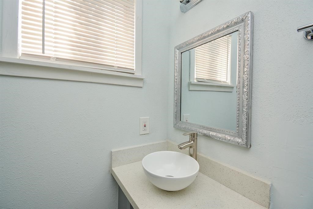 917 Defender Street Houston, TX 77029 - Photo 13 of 14 a bathroom with a sink and a mirror