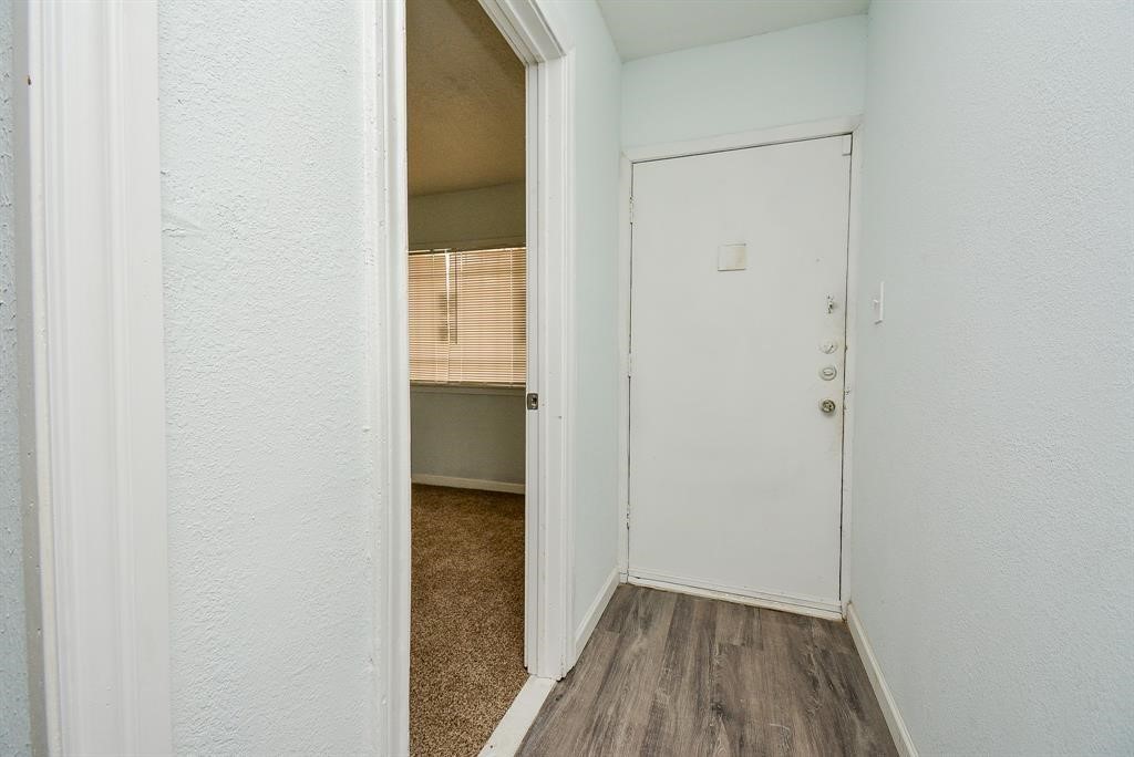 917 Defender Street Houston, TX 77029 - Photo 3 of 14 a view of a hallway with wooden floor