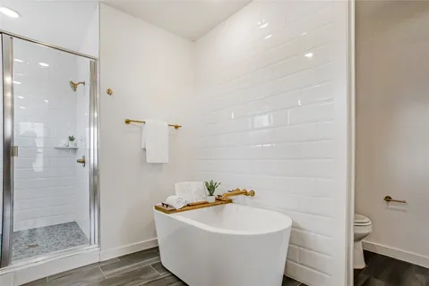 a white bath tub sitting next to a white sink