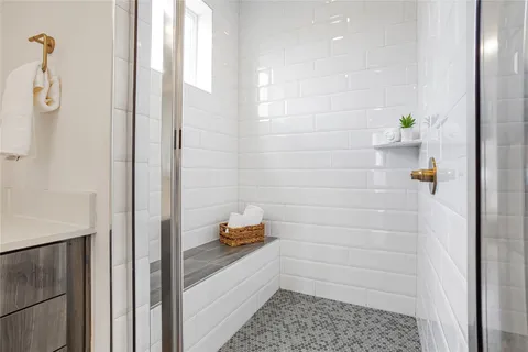 a bathroom with a bathtub and shower
