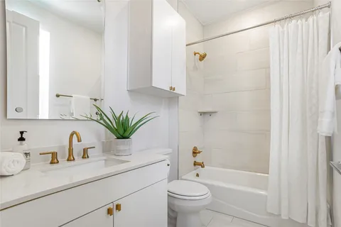 a bathroom with a sink a mirror a potted plant and a shower