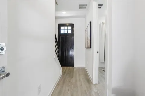 a view of hallway with wooden floor