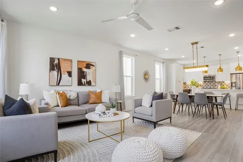 a living room with furniture and wooden floor