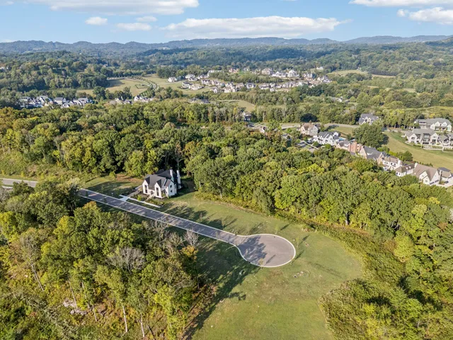 a view of a swimming pool with a table and chairs in the ocean