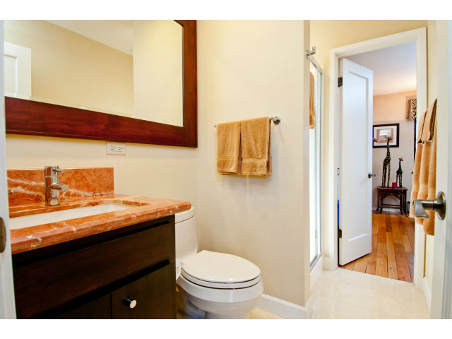 2697 Pradera Road Carmel, CA 93923 - Photo 17 of 22 a bathroom with a granite countertop sink a toilet and a mirror