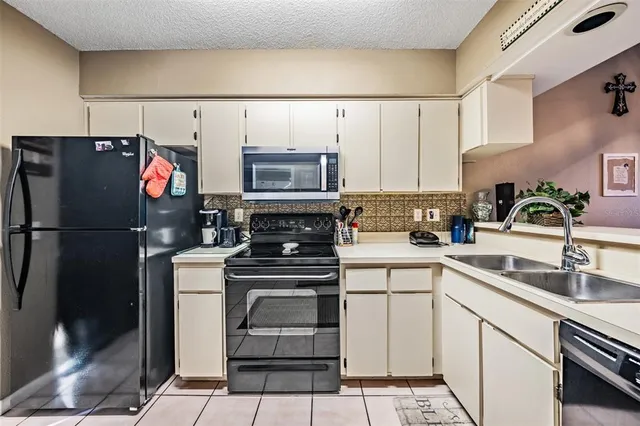 a kitchen with a stove top oven and cabinets