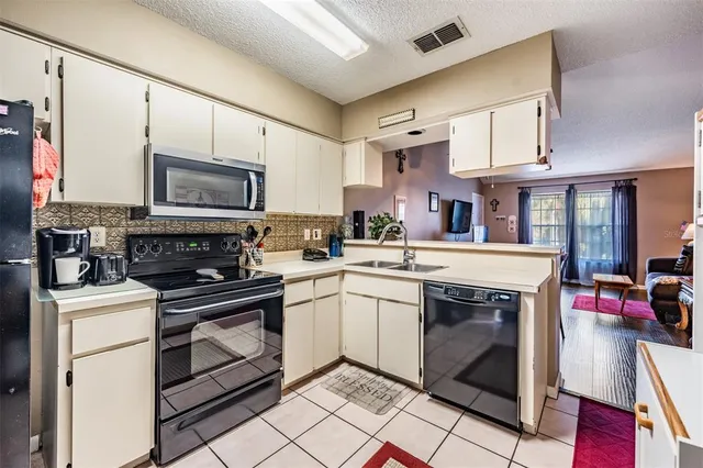 a kitchen with a sink stove and cabinets