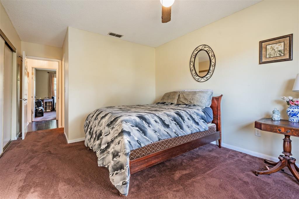 6338 Spring Flower Drive, Unit 21 New Port Richey, FL 34653 - Photo 17 of 35 a bedroom with a bed and a chandelier