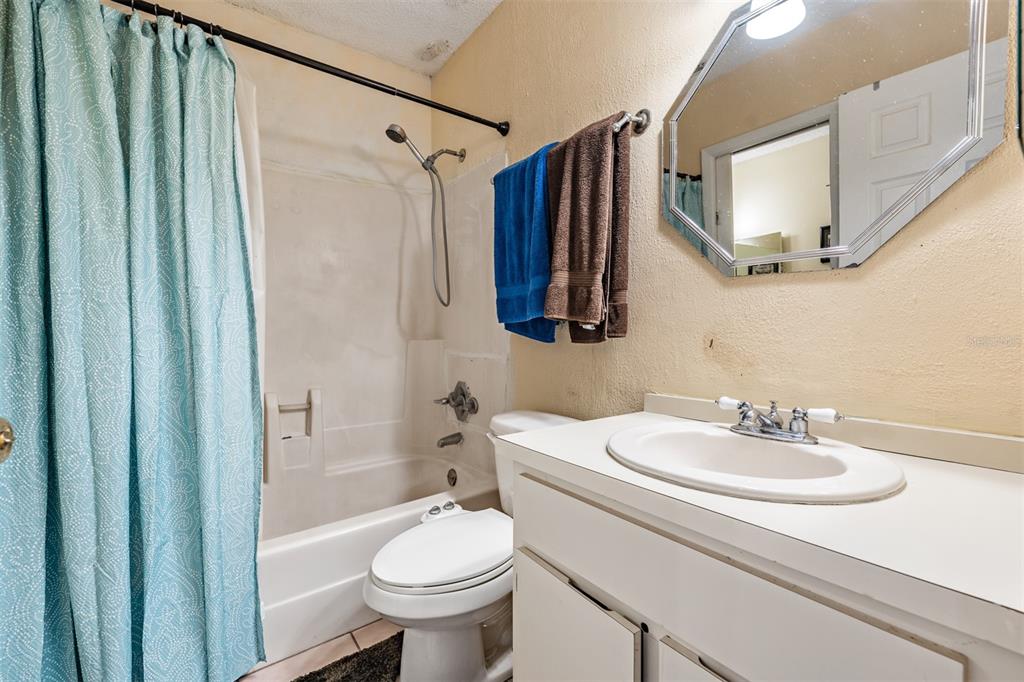 6338 Spring Flower Drive, Unit 21 New Port Richey, FL 34653 - Photo 19 of 35 a bathroom with a sink toilet and shower