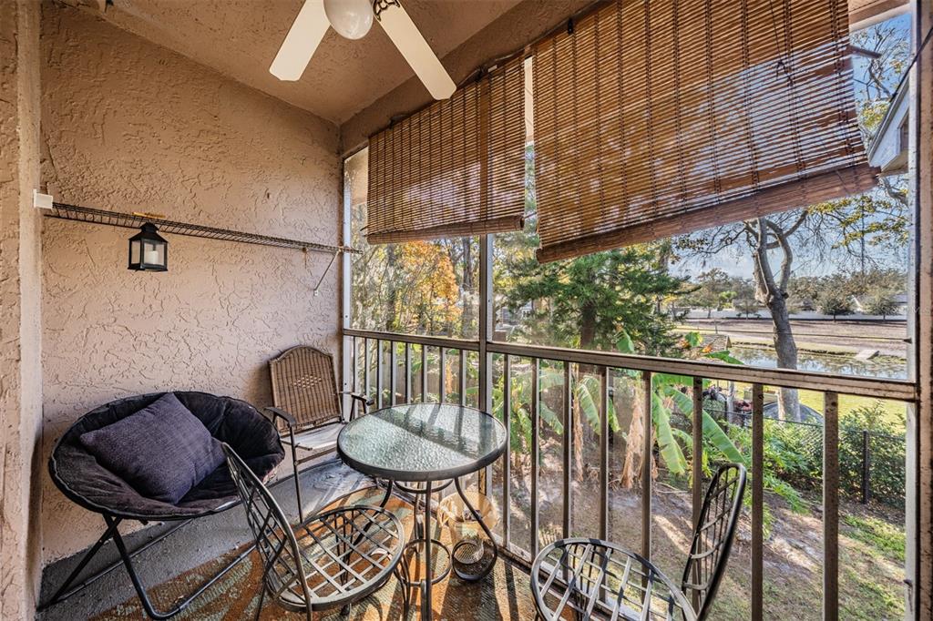 6338 Spring Flower Drive, Unit 21 New Port Richey, FL 34653 - Photo 21 of 35 a view of a chairs and table in the balcony