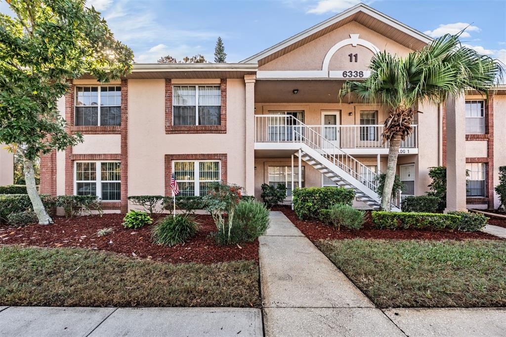 6338 Spring Flower Drive, Unit 21 New Port Richey, FL 34653 - Photo 22 of 35 a front view of a house with garden