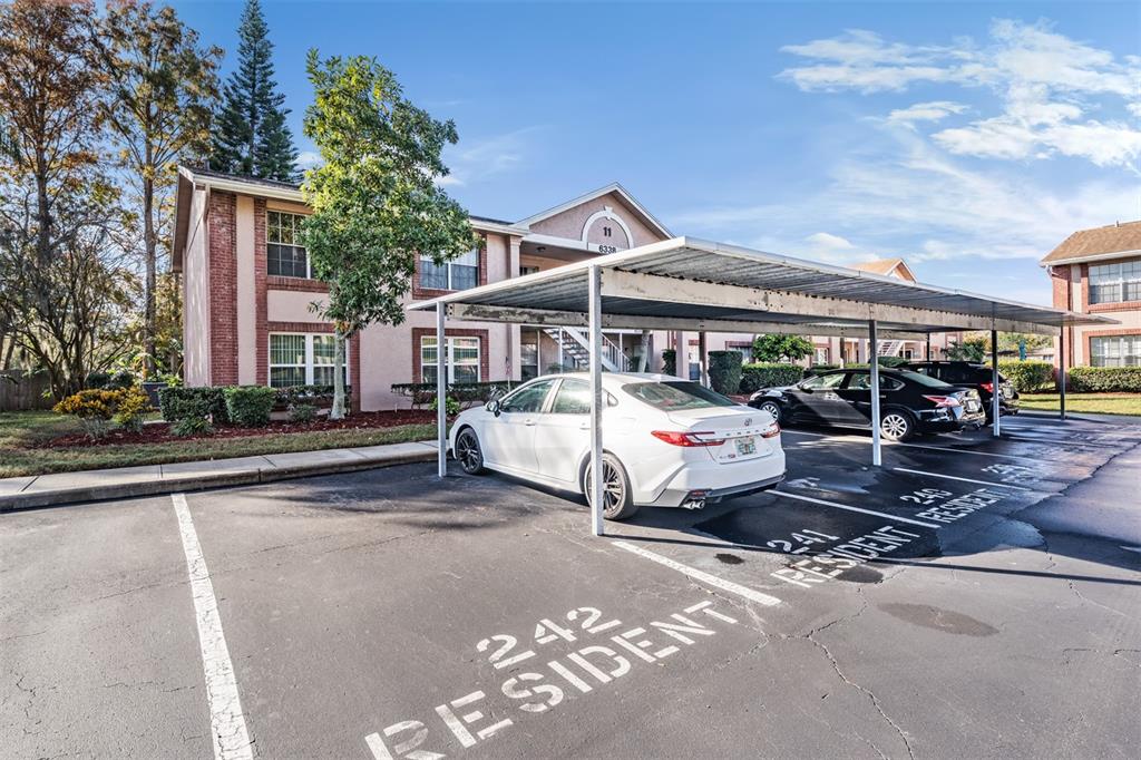 6338 Spring Flower Drive, Unit 21 New Port Richey, FL 34653 - Photo 24 of 35 a car parked in front of white house