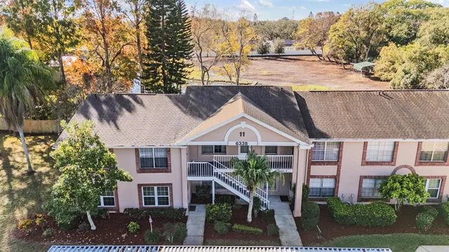 an aerial view of a house with swimming pool and patio
