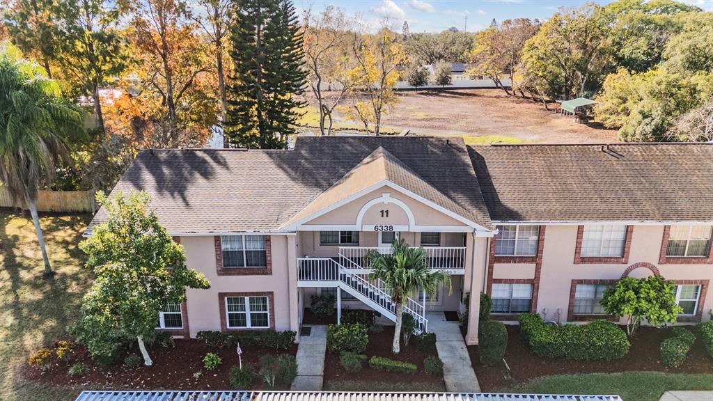 6338 Spring Flower Drive, Unit 21 New Port Richey, FL 34653 - Photo 26 of 35 front view of a house with a yard