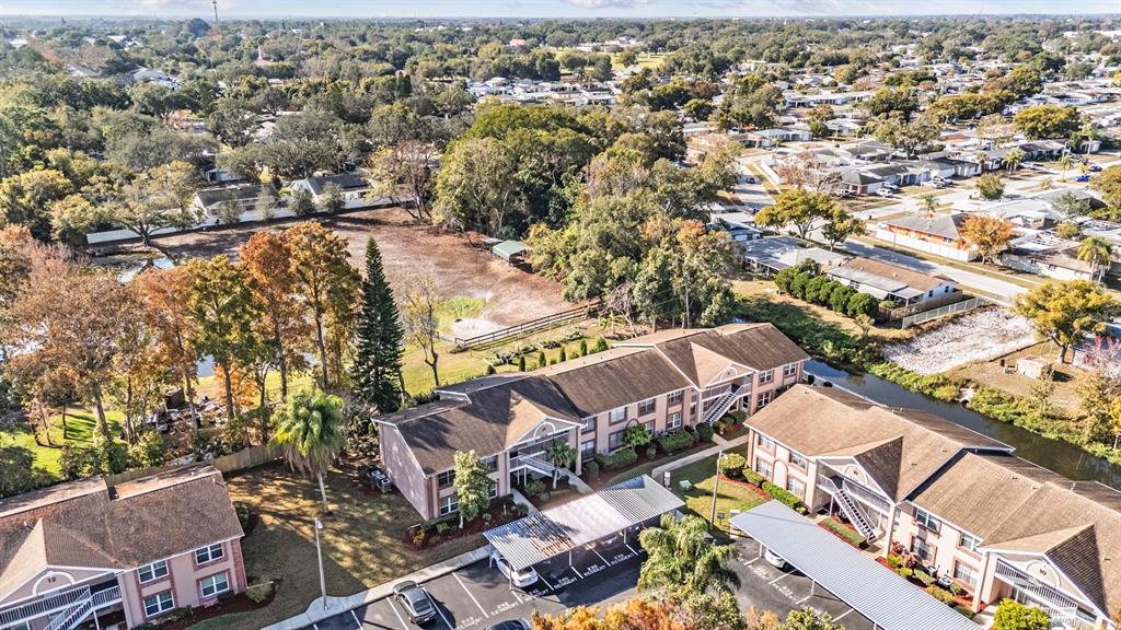 6338 Spring Flower Drive, Unit 21 New Port Richey, FL 34653 - Photo 29 of 35 an aerial view of a house with a yard and lake view in back