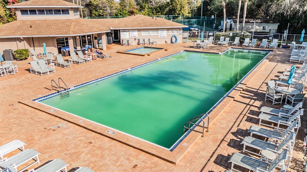 6338 Spring Flower Drive, Unit 21 New Port Richey, FL 34653 - Photo 34 of 35 a view of swimming pool and chairs in patio