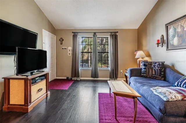 a living room with furniture a wooden floor and a table