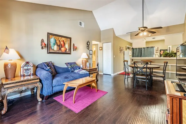 a living room with furniture and wooden floor