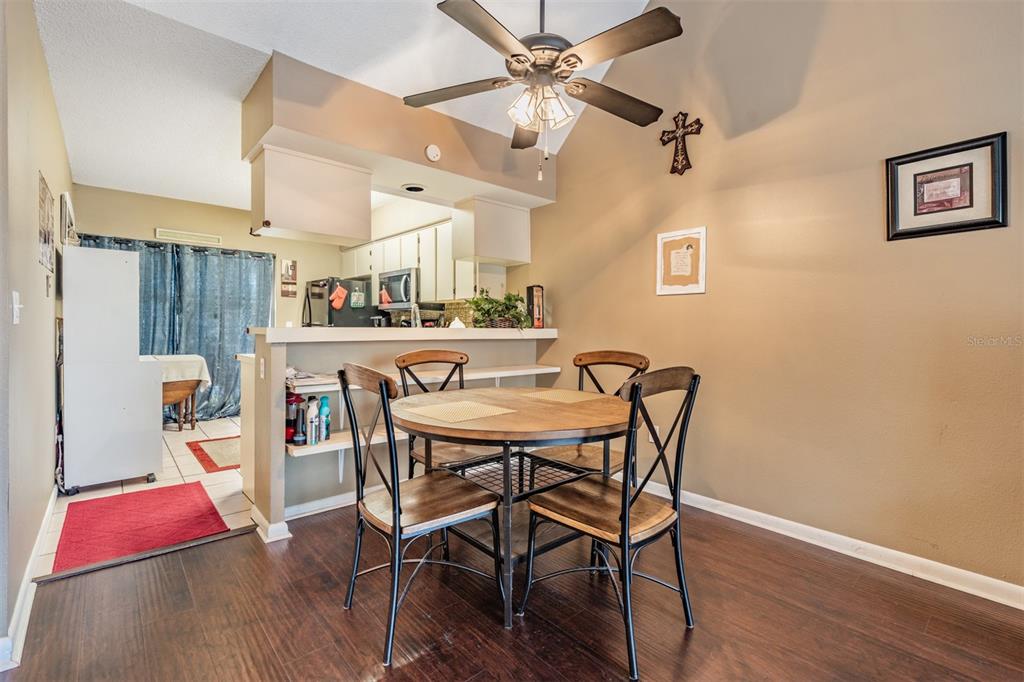 6338 Spring Flower Drive, Unit 21 New Port Richey, FL 34653 - Photo 9 of 35 a dining room with furniture and a chandelier fan