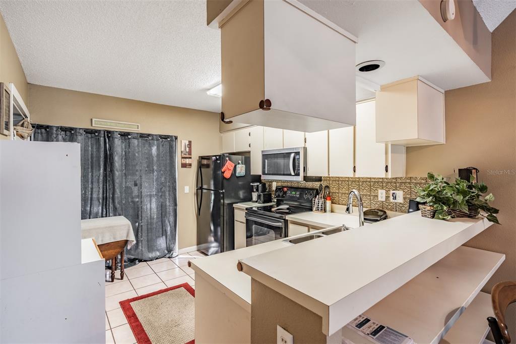 6338 Spring Flower Drive, Unit 21 New Port Richey, FL 34653 - Photo 10 of 35 a kitchen with a sink a stove and a refrigerator