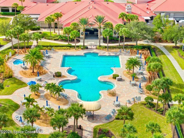 a living room with furniture a flat screen tv and a window