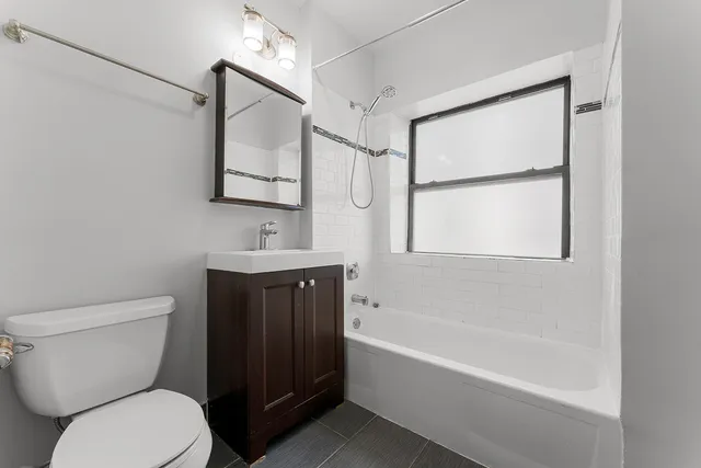 a bathroom with a toilet a sink and bathtub