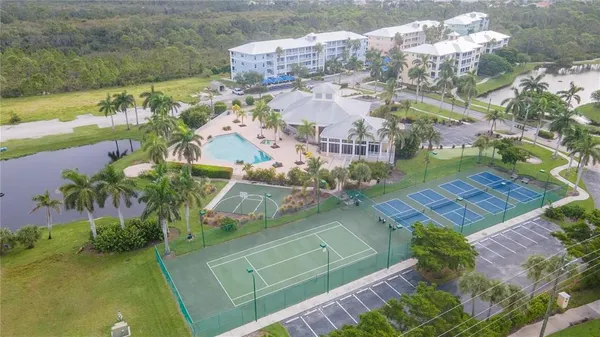 an aerial view of residential houses with outdoor space and swimming pool
