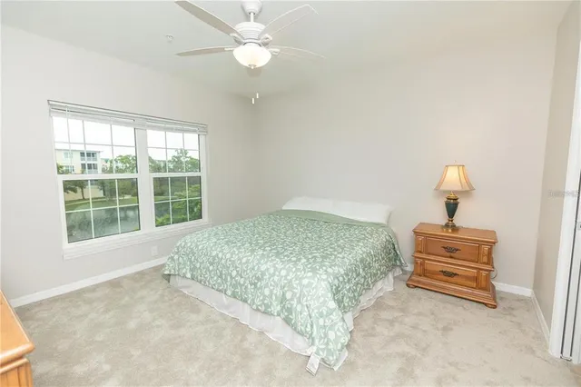 a bedroom with a bed dresser and a window