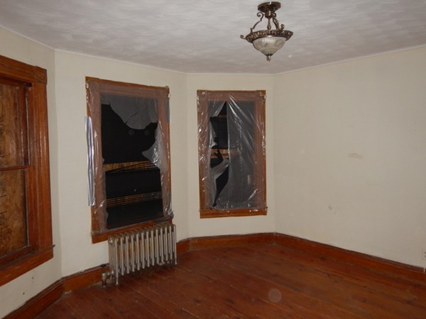 31-33 Collins Street Springfield, MA 01109 - Photo 5 of 30 a view of a hallway with wooden floor and closet