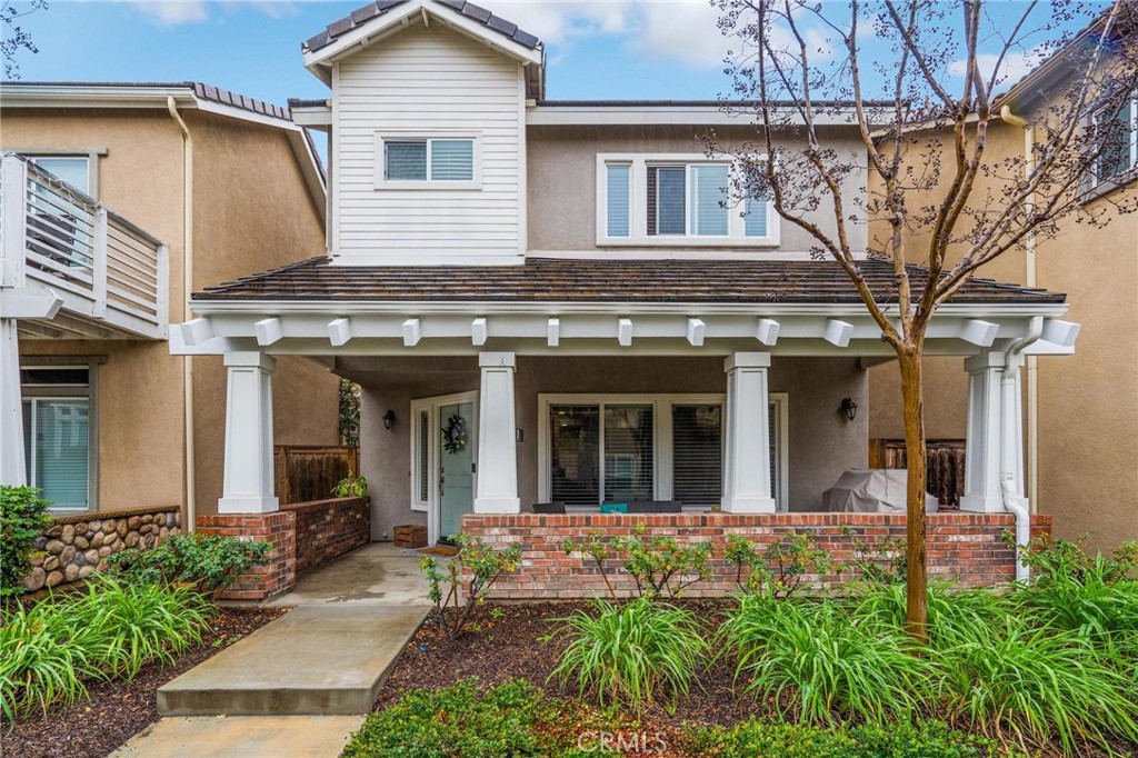 6371 Juneberry Way Riverside, CA 92504 - Photo 1 of 1 a view of a white house with large windows and flower plants