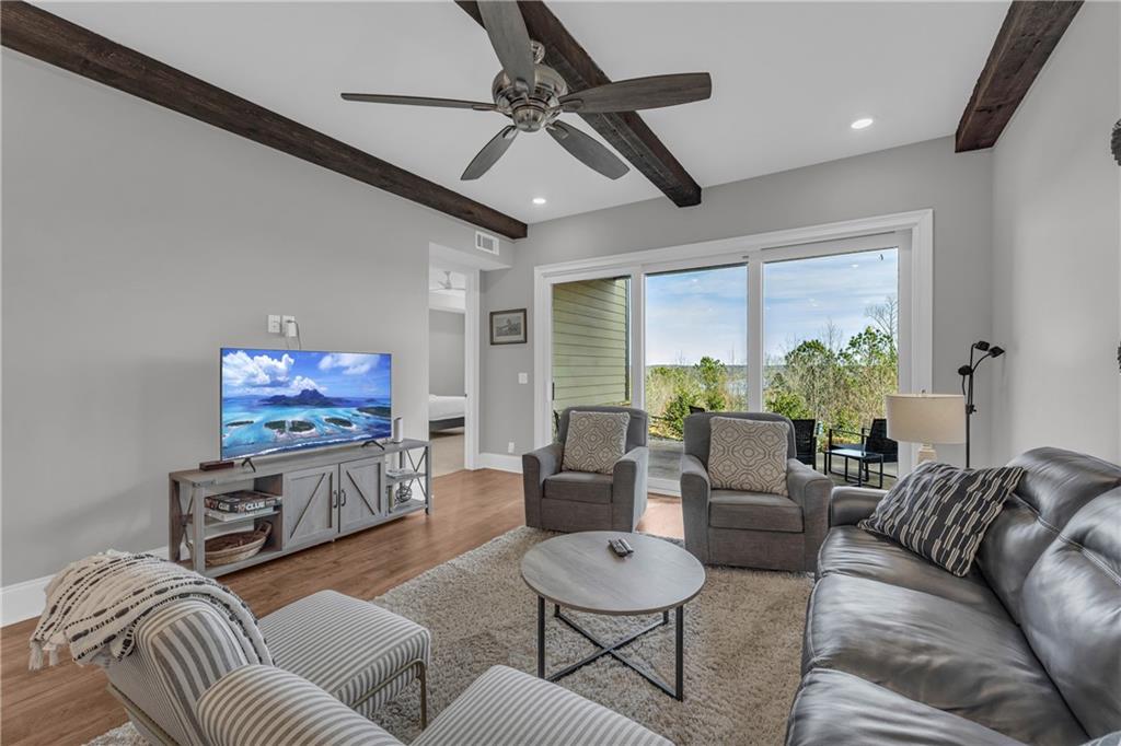 17 Cottage Lane Toccoa, GA 30577 - Photo 34 of 50 a living room with furniture a flat screen tv and a large window