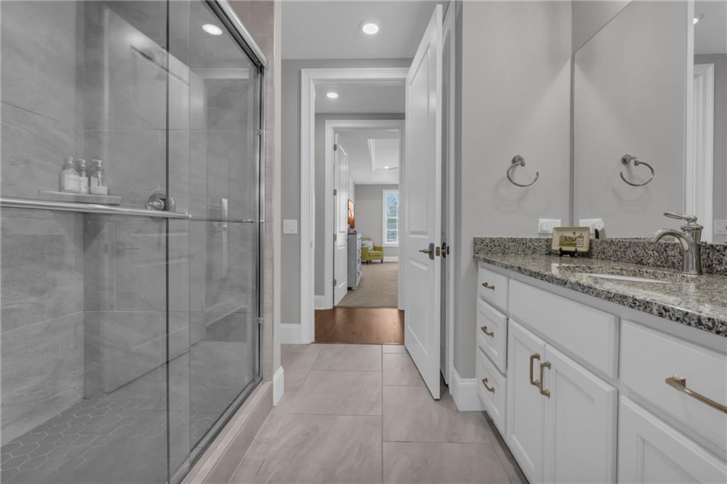 17 Cottage Lane Toccoa, GA 30577 - Photo 42 of 50 a spacious bathroom with a granite countertop sink a mirror and shower