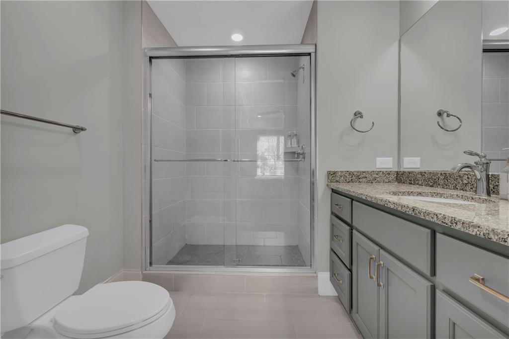 17 Cottage Lane Toccoa, GA 30577 - Photo 48 of 50 a bathroom with a granite countertop sink a toilet and shower