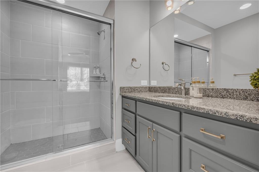 17 Cottage Lane Toccoa, GA 30577 - Photo 49 of 50 a bathroom with a granite countertop sink mirror and shower