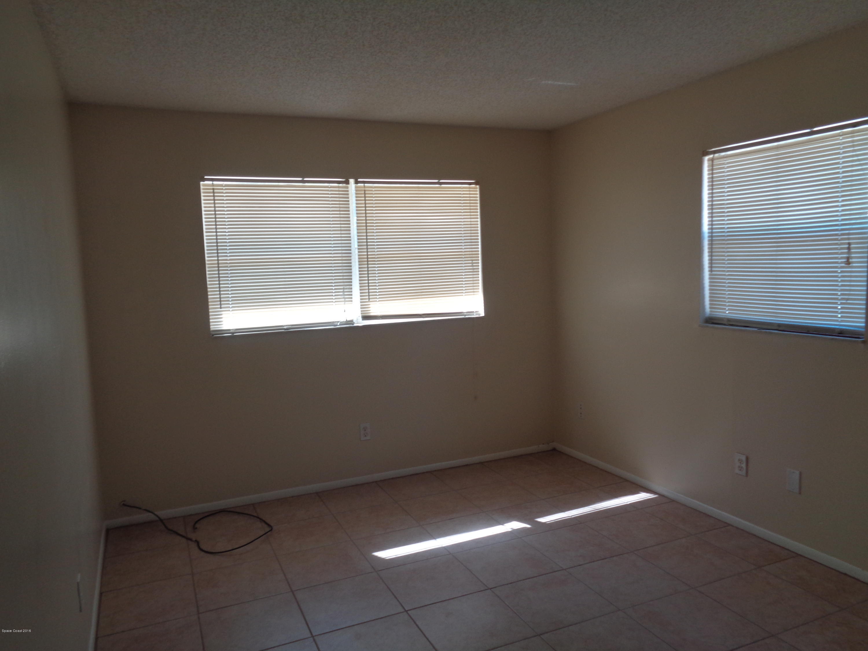120 Olive Street Cocoa, FL 32922 - Photo 5 of 7 an empty room with a window
