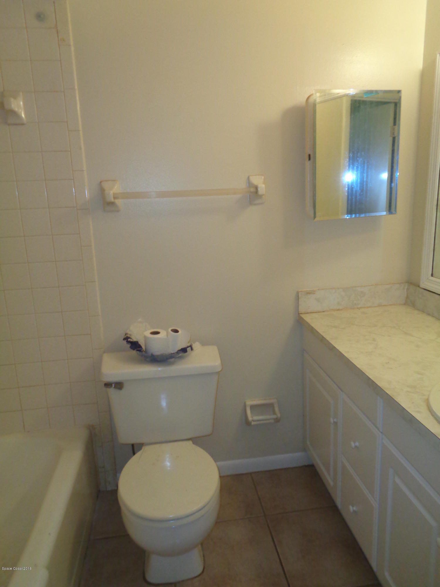 120 Olive Street Cocoa, FL 32922 - Photo 7 of 7 a bathroom with a granite countertop toilet and a sink