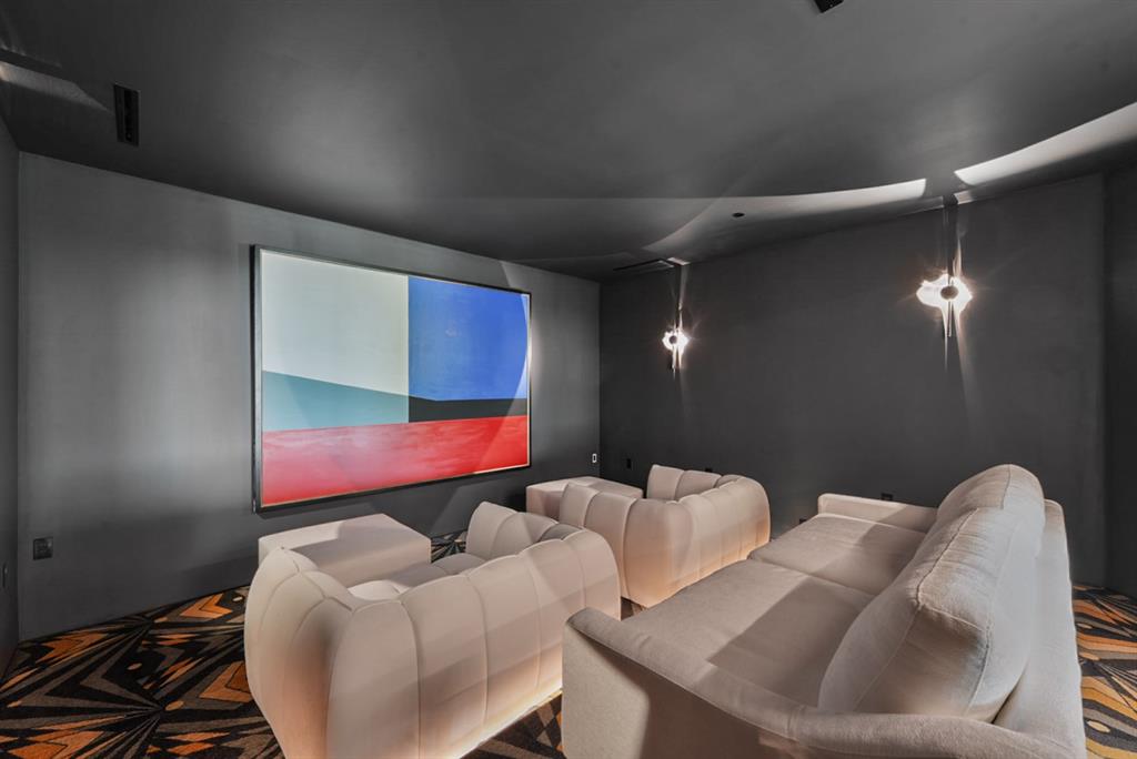 9457 Waterview Road Dallas, TX 75218 - Photo 20 of 25 Dedicated media room featuring dark walls and ceiling, recessed lighting, and a projection screen