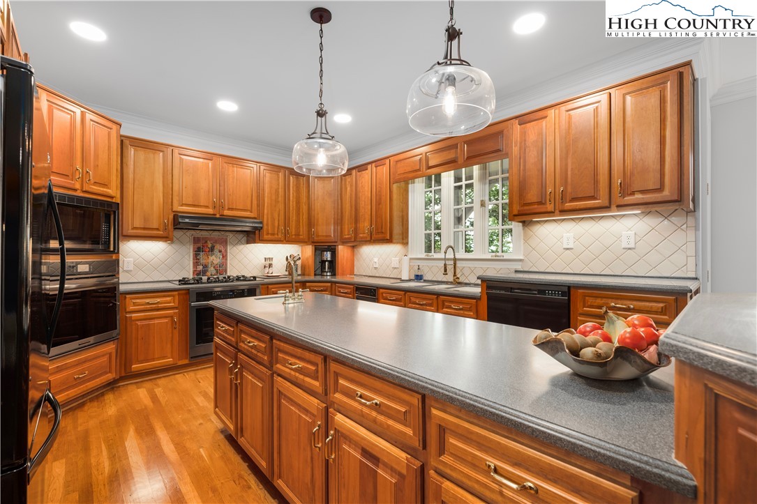 738 Country Club Road Glade Valley, NC 28627 - Photo 20 of 45 a kitchen with stainless steel appliances granite countertop a sink a stove and a refrigerator