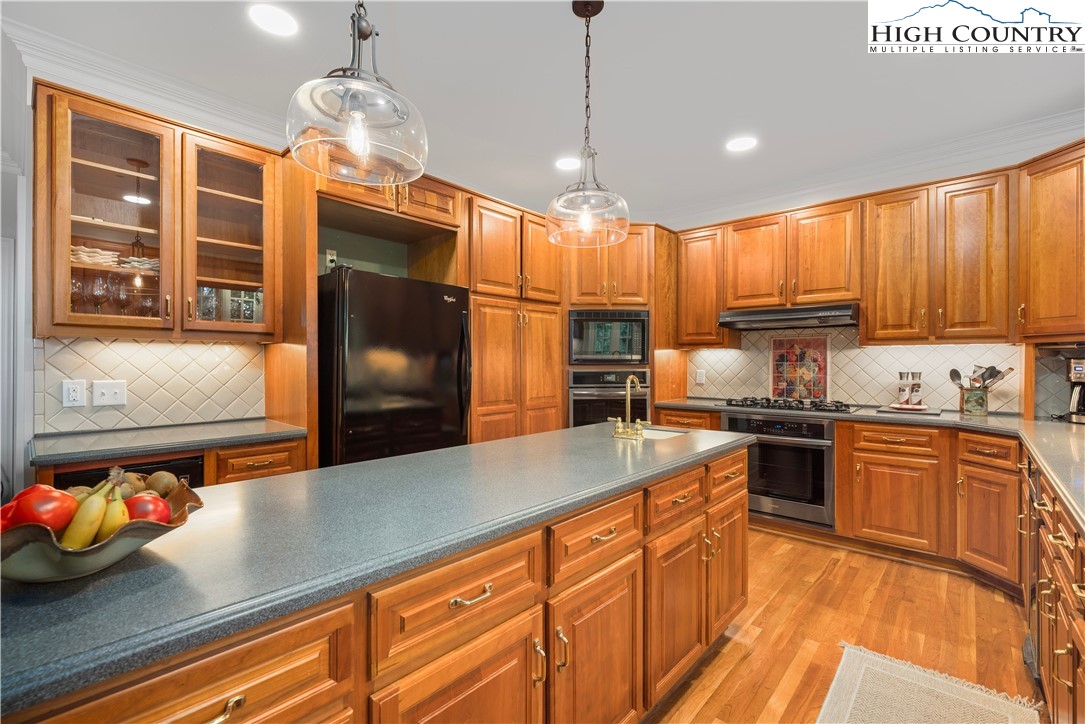 738 Country Club Road Glade Valley, NC 28627 - Photo 21 of 45 a kitchen with stainless steel appliances granite countertop a sink a stove and a refrigerator