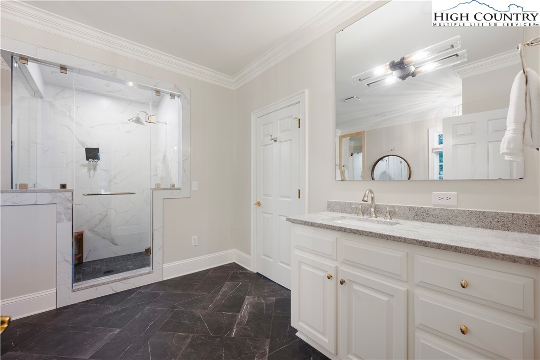 738 Country Club Road Glade Valley, NC 28627 - Photo 28 of 45 a bathroom with a sink and mirror