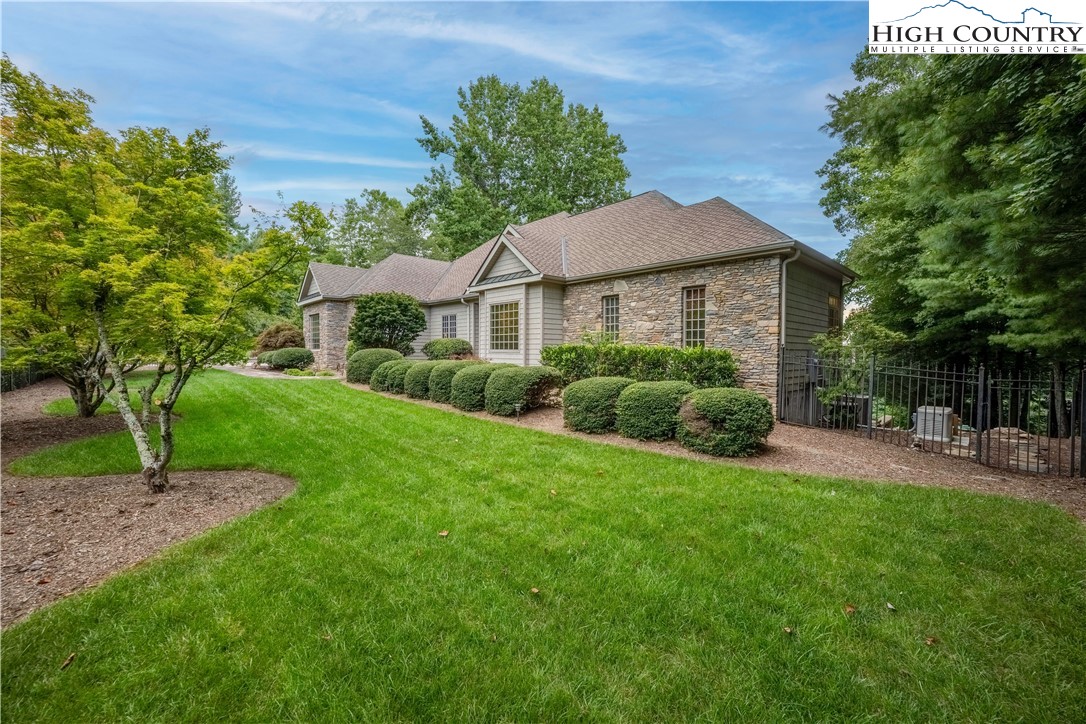738 Country Club Road Glade Valley, NC 28627 - Photo 3 of 45 a front view of a house with garden