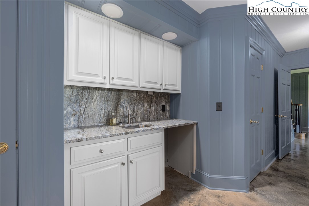 738 Country Club Road Glade Valley, NC 28627 - Photo 38 of 45 a kitchen with granite countertop white cabinets and sink