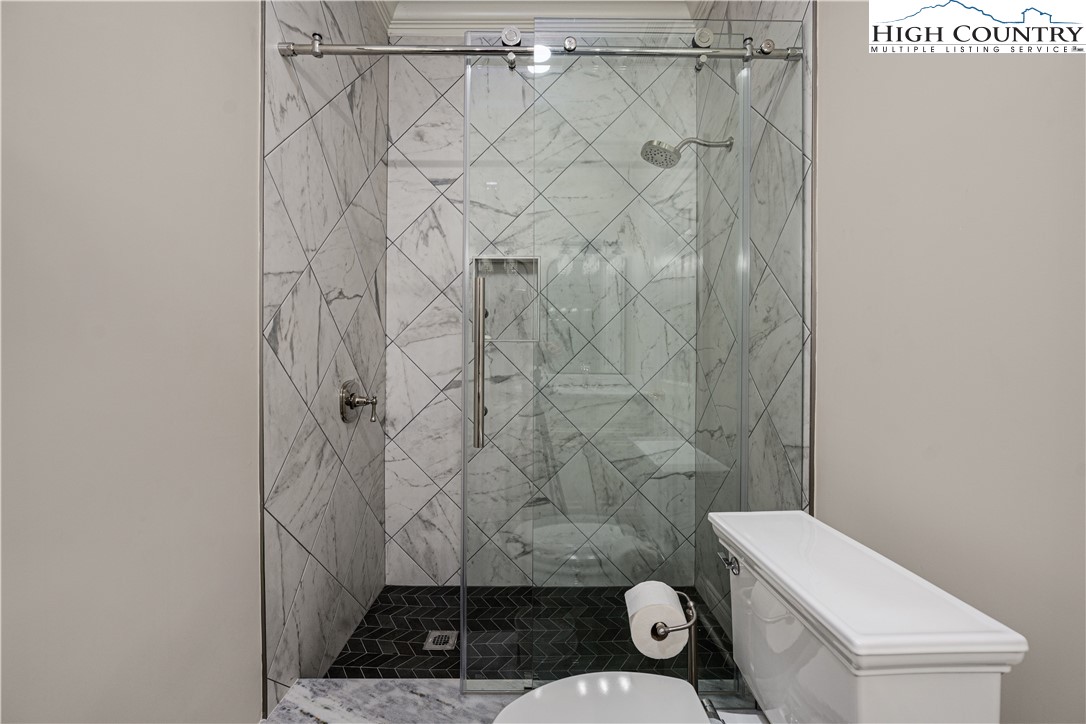 738 Country Club Road Glade Valley, NC 28627 - Photo 42 of 45 a bathroom with a toilet and a shower